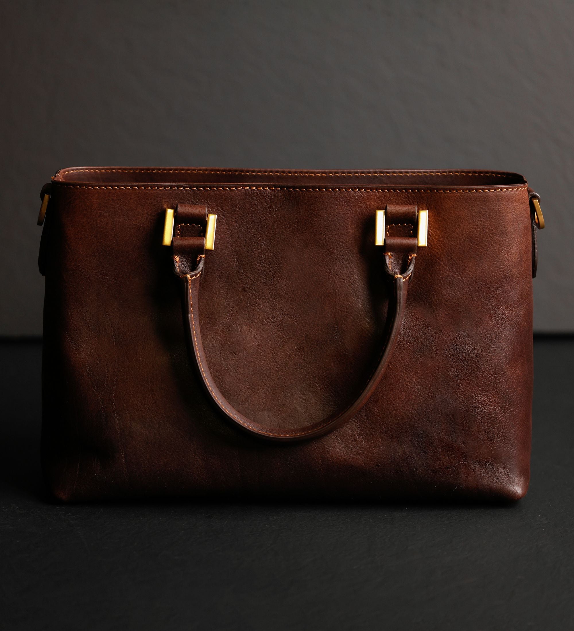 Rückseite der schokoladenbraunen Camilla Schultertasche mit den Schlaufen für die Henkel